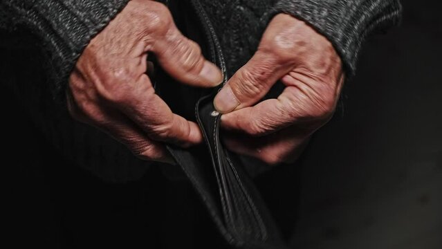 Close up Empty wallet in senior hands, opens and empty, no money. Poverty in retirement concept