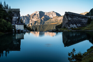 Fototapeta premium Ripples in the water created by a small rock thrown into the Lake Gleno, in the Orobie Alps