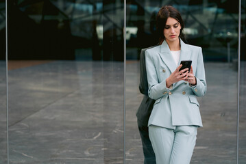 Businesswoman using mobile phone in city