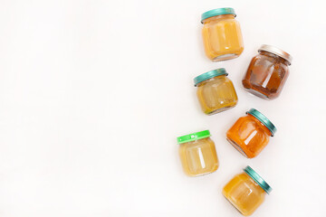 Layout of Puree for baby food with vegetables and fruits. Selective focus. nutrition. The first complementary feeding of the child. A happy child. A well-fed child. Copy space.