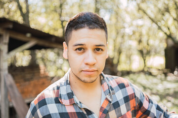 Ethnic man in checkered shirt in countryside