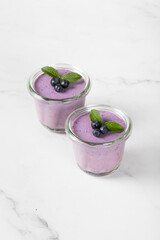 Vegan dessert. Blueberry cream jelly pudding, Panna Cotta in a glass. Light background