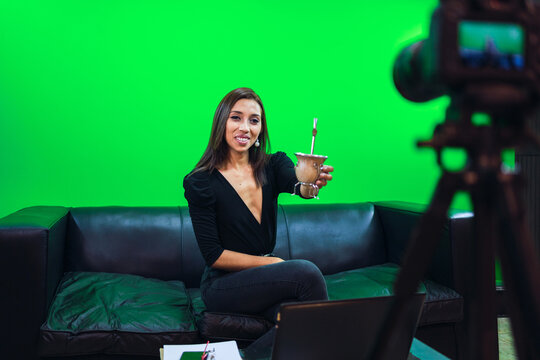 Smiling woman showing mate cup for video
