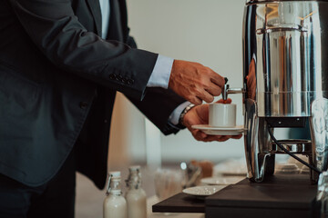 Close-up photo of businessmen serving themselves in a modern hotel during a dinner party. Selective focus 