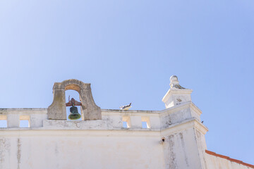 Bell on the roof of an old Portuguese Catholic church