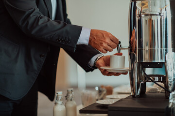 Close-up photo of businessmen serving themselves in a modern hotel during a dinner party. Selective focus 