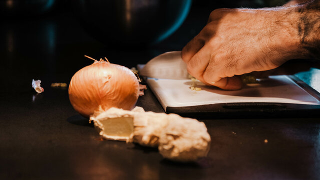 Man cutting onion in a kitchen