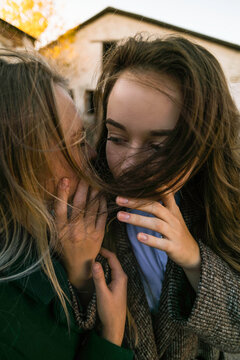 Two excited young girls, people, communication and friendship concept