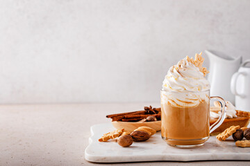 Pumpkin spice latte topped with whipped cream and cinnamon - obrazy, fototapety, plakaty