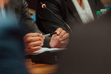 Close-up of male hands with pen over document. Selective focus 