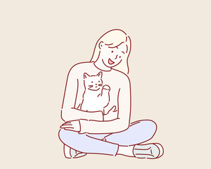 Young woman holds in her arms and hugs cat.