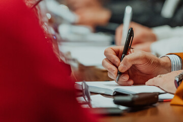 Close-up of male hands with pen over document. Selective focus 