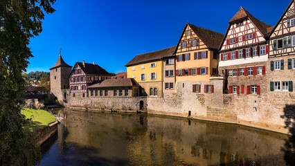 Fototapeta na wymiar Idyllic panorama in a German old town on a river with city wall and half-timbered houses