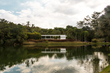Fototapeta na wymiar Lake and a construction for the visitors of the Inhotim Park at Brumadinho, State of Minas Gerais, Brazil.