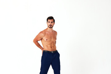 Fototapeta premium Man with bare torso and prue cubes in business pants shows full-length nude body, women's day March 8 on white isolated background copy space 