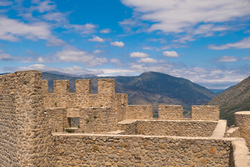 Castle battlements, a view of the battlements of the ancient historical castle with a cloudy blue sky