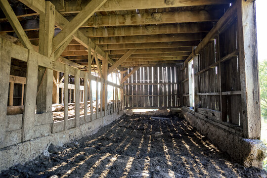 Old Barn Interior with Sun Shinning Through Wood