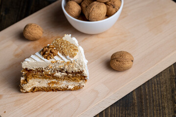 a piece of cake with buttercream and walnuts