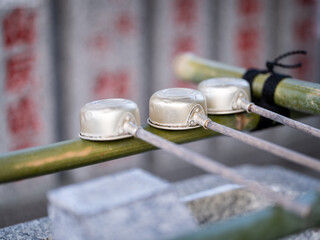 closeup of ladle used for purification at the entrance of a shinto shrine in tokyo, Japan