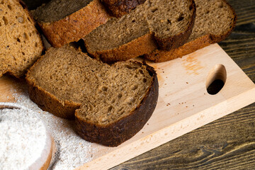 sliced rye bread on a wooden table, close up