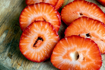 Ripe red strawberries lying on a wooden tray