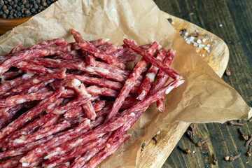 thin dried meat sausages with spices , close up