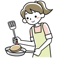 エプロンを着けて料理をする笑顔の若い女性