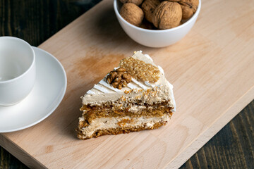 a piece of cake with buttercream and walnuts