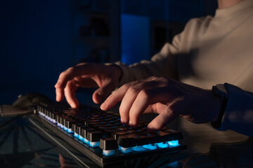 financier works in an online trading terminal, cryptocurrency exchanges and securities exchanges. The investor works late in international markets, a dark cabinet, an image with a small depth of focus