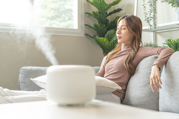 Air Humidifier Device At home and Woman relaxing on the sofa