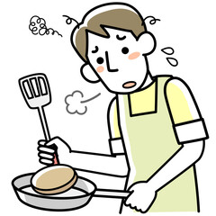 疲れた表情で料理を作る若い男性