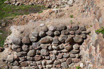 The old wall of the building is made of stones and cobblestones