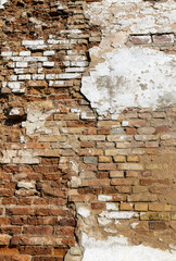 An old brick wall with various damages