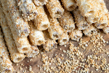 waffle tube with chocolate filling and crushed peanuts