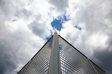 Metal grating on a blue sky background