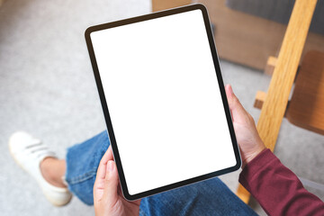 Top view mockup image of a woman holding digital tablet with blank white desktop screen