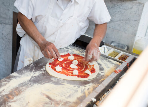 Chef preparing a traditional wood fired pizza