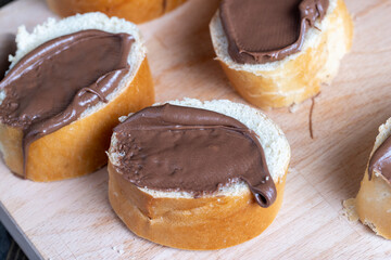 Chocolate butter spread on bread while cooking breakfast
