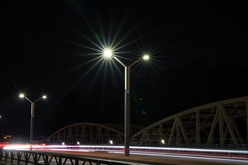 Fototapeta na wymiar 夜景街灯の光線と自動車のテールランプのレーザービーム