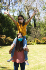 Portrait of caucasian woman and her daughter spending time in their garden together