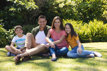 Portrait of caucasian family spending time in their garden together