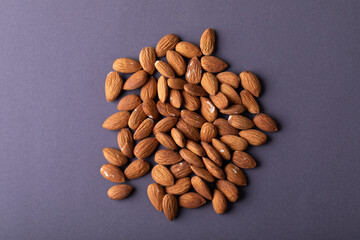 Overhead close-up shot of nutritious almonds on gray background