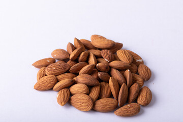 Close-up of nutritious almonds on white background