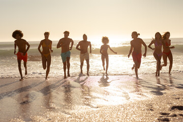 Multi-ethnic group of male and female standing on the beach