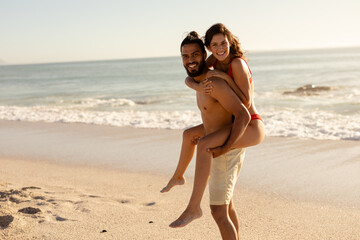 Fototapeta na wymiar Caucasian couple having fun on the beach