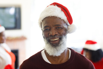 Portrait of senior african american man wearing santa hat