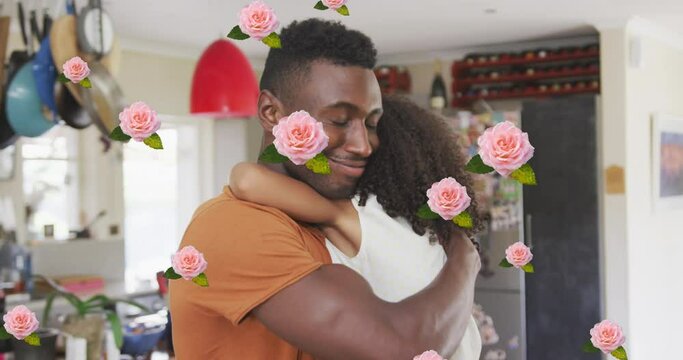 Animation of roses over african american father hugging his daughter