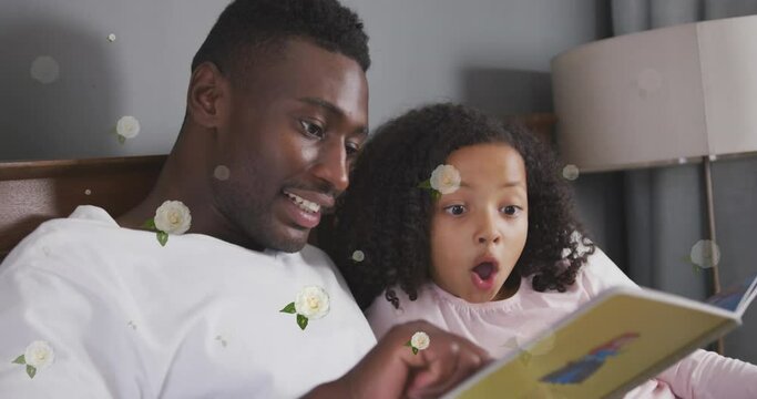Animation of roses over happy african american father and daughter reading book