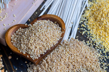 Fresh uncooked bulgur porridge on the table