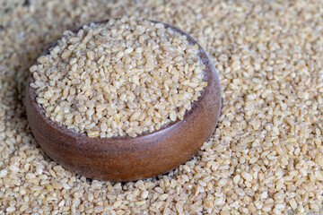 Fresh uncooked bulgur porridge on the table